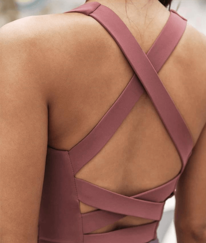 Back view of women's sexy cross back running tank top in pink, designed for high-intensity workouts with breathable nylon and spandex.
